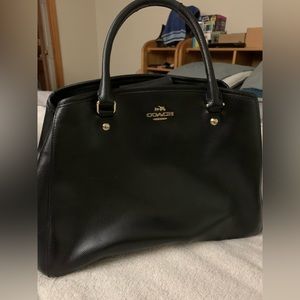Black Coach bag. Some damage on handles. Opens to two sides and 1 zipped pocket